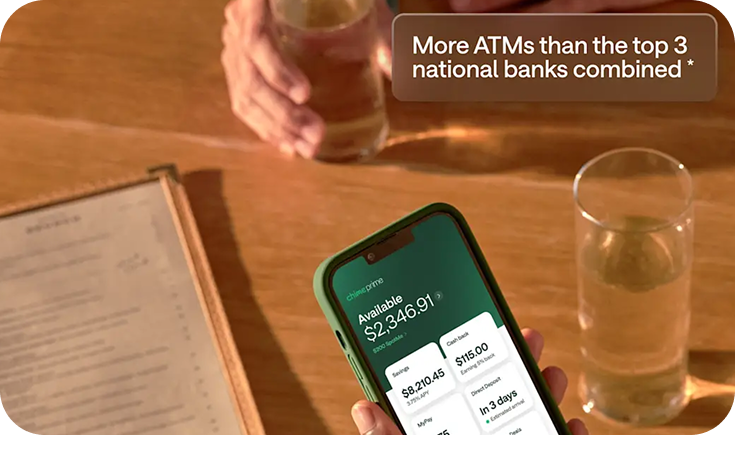 Chime banking app displayed on a phone at a restaurant table