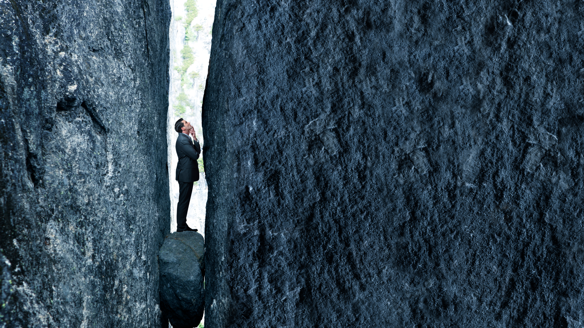 An image of a person thinking his way out of a deep ravine.