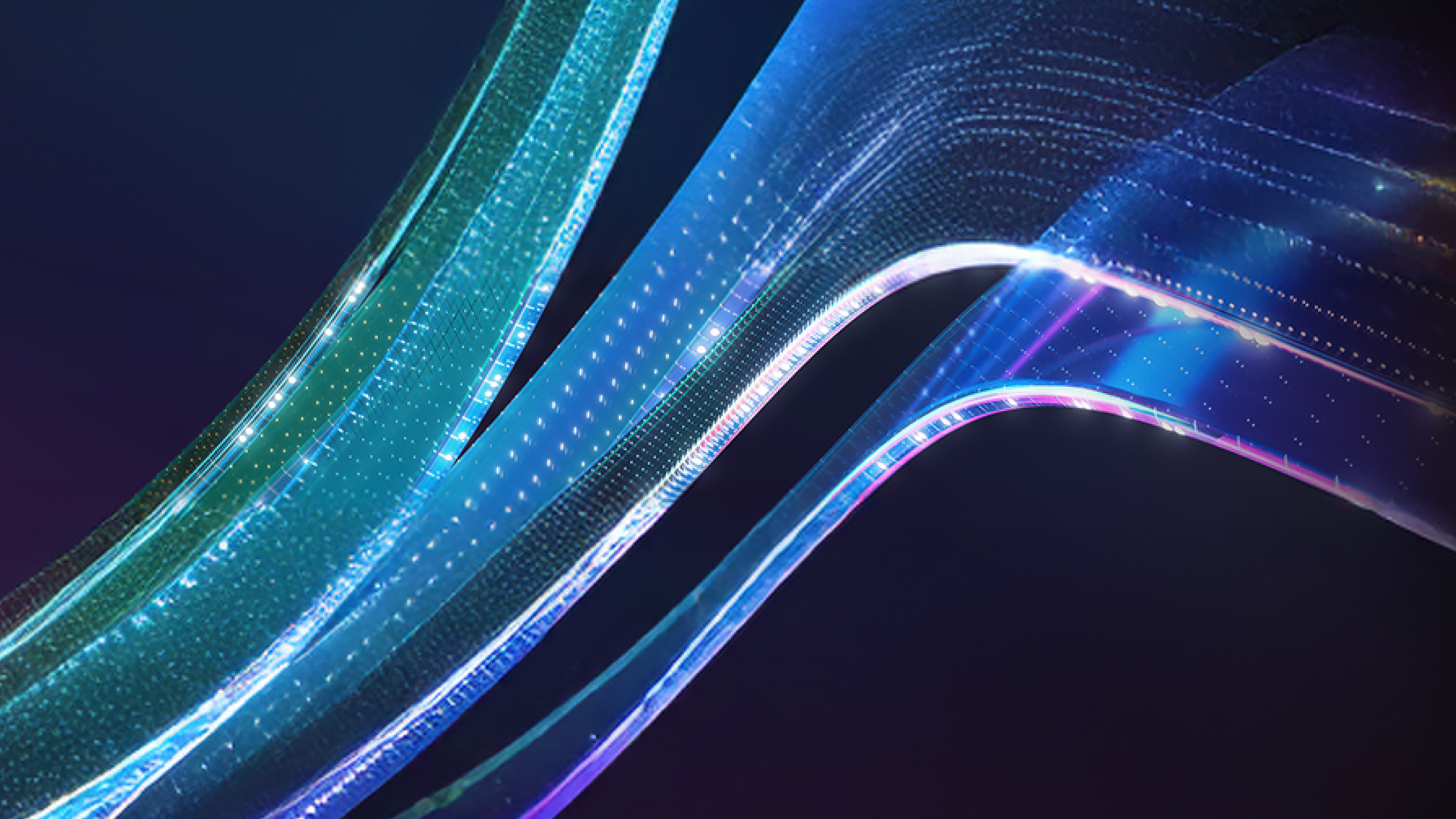 Green, blue, and purple waves of light reflecting on glass across a black background.