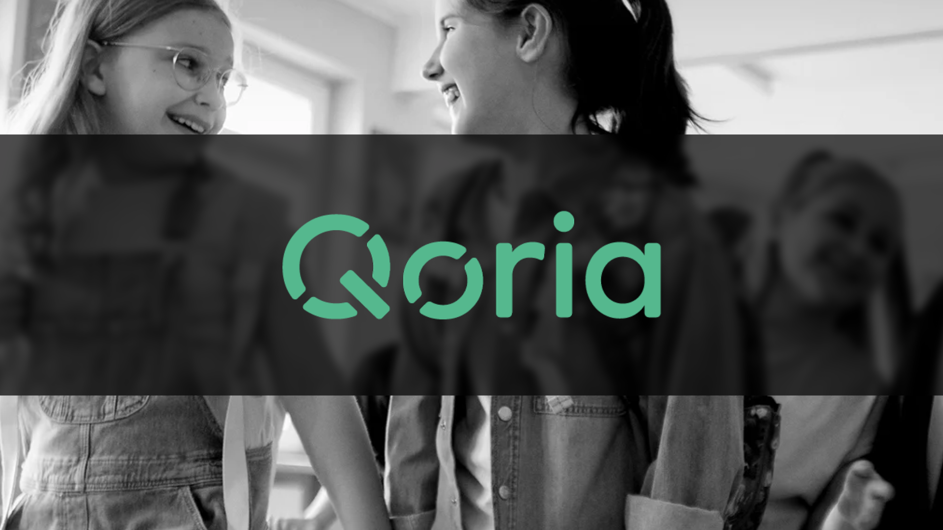 The Qoria logo overlaid on a classroom scene.