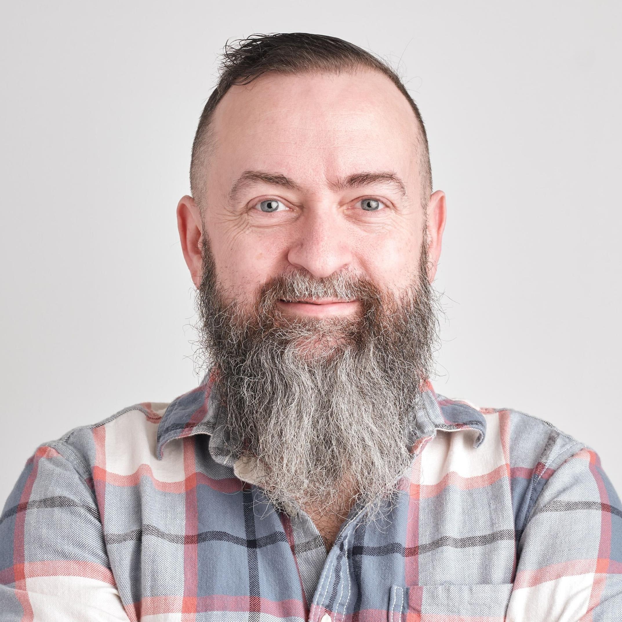A headshot of Mike Geehan, Senior Director of Engineering and Head of Information Security at Cockroach Labs, in front of a plain, neutral background.
