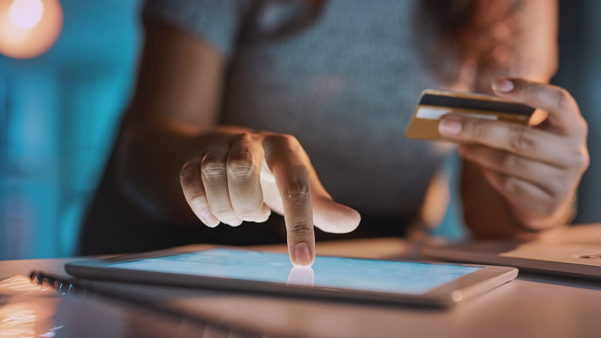 A picture of a retail consumer using digital devices to shop online.