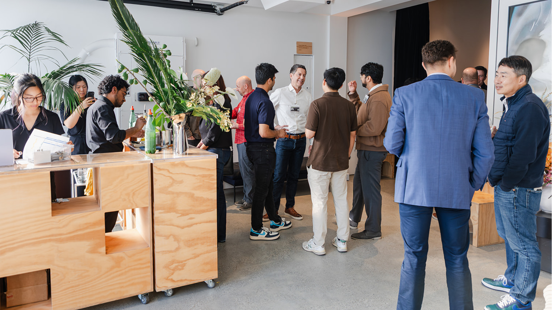 Group of professionals networking and discussing at a Cockroach Labs event, capturing real-world conversations about AI, infrastructure, and systems at scale.