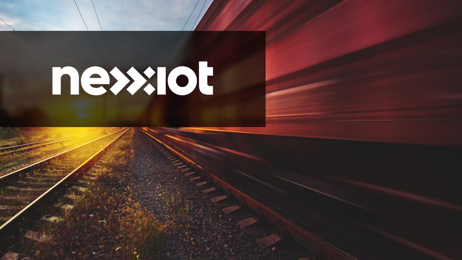 An image of a fast-moving train with the Nexxiot logo.